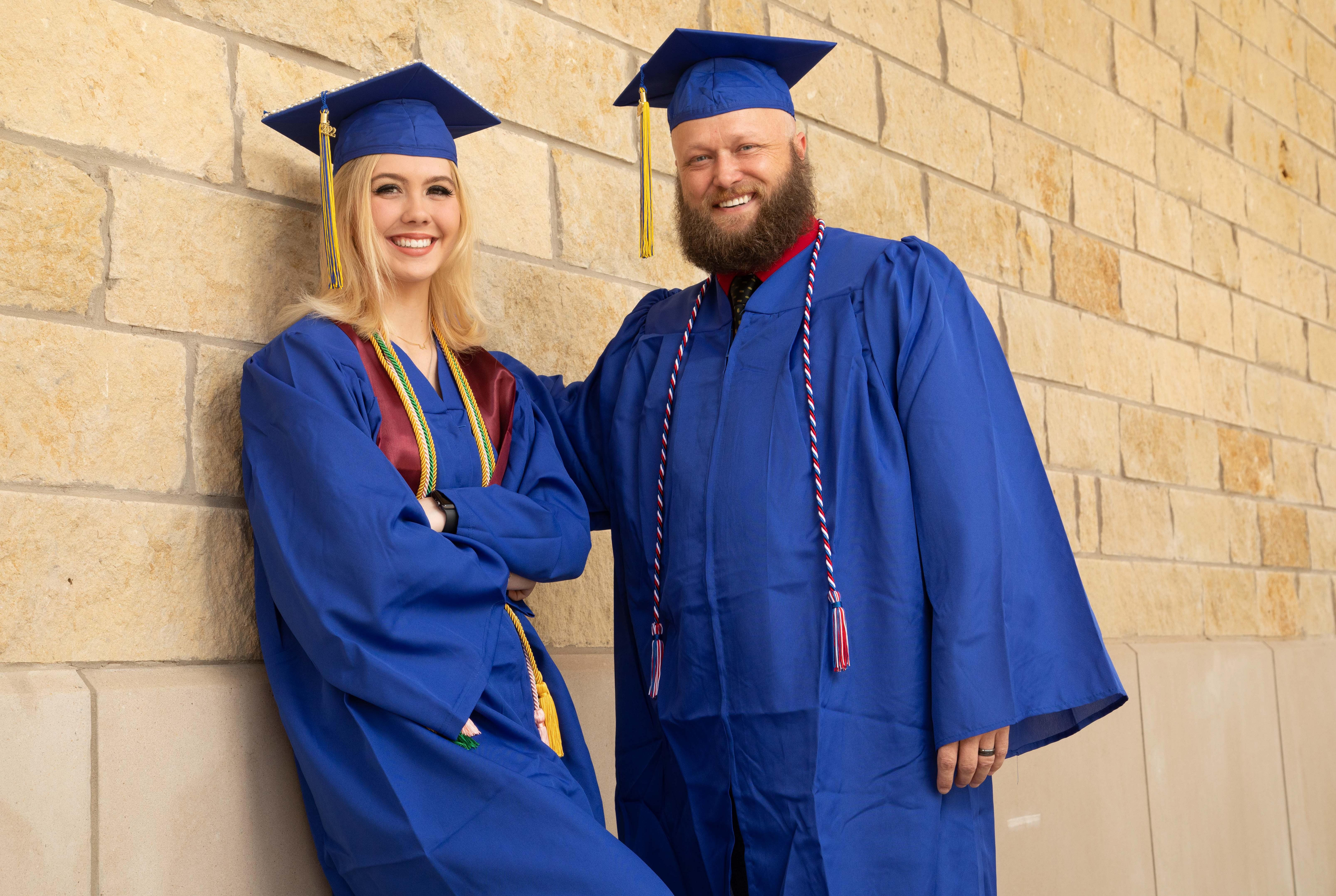 Dawayne Krepel and his daughter Kathryn, who graduated with associate degrees from Barton Community College at the ages of 42 and 18, respectively, pose for a photo before the Fort Riley Education Services commencement ceremony Thursday afternoon at Manhattan. Dawayne finished his associate degree after retiring from his second vocation, while his daughter finished hers before graduating high school.